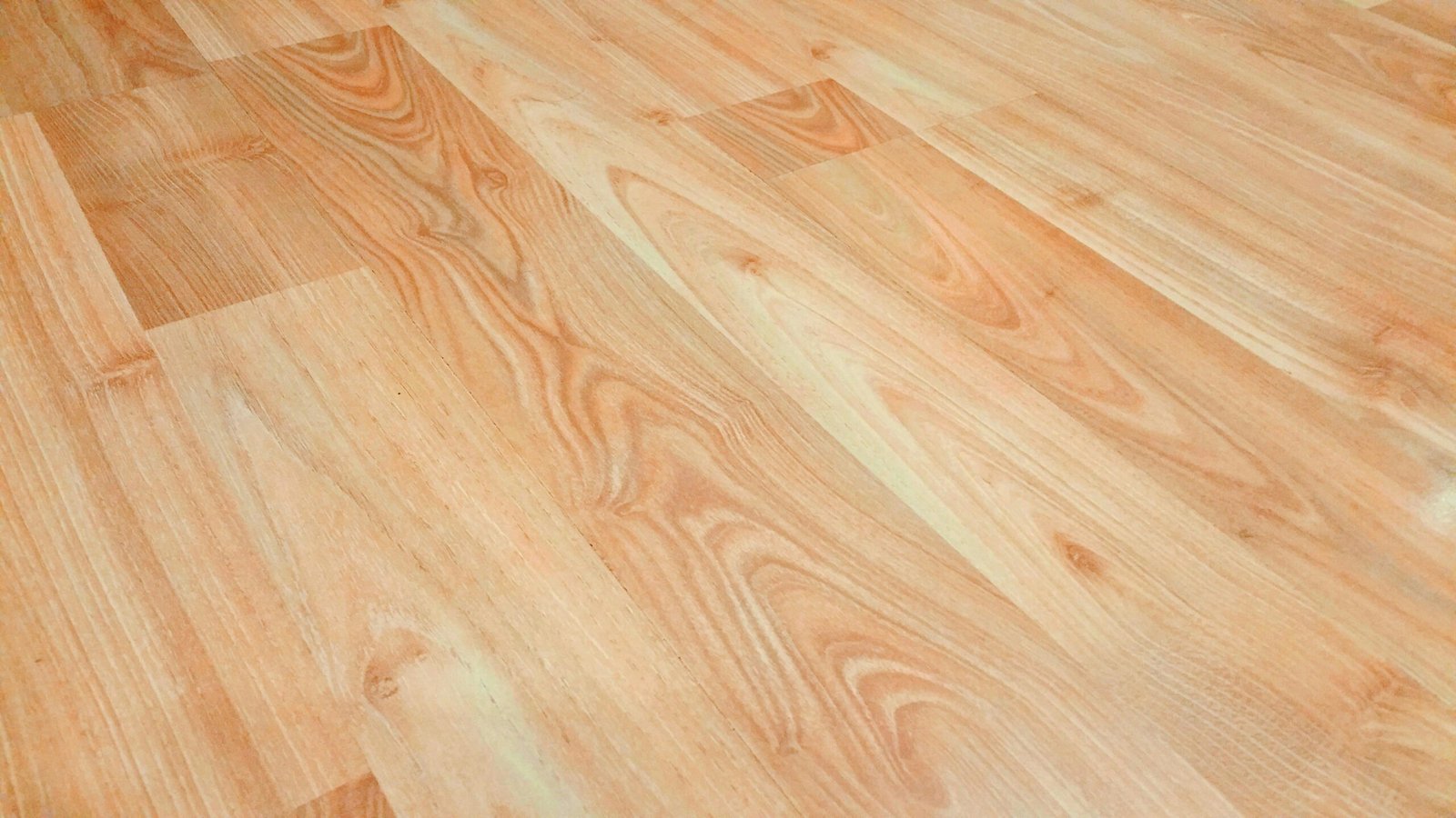 Detailed wooden floor texture background showcasing natural wood grain and patterns for design use.